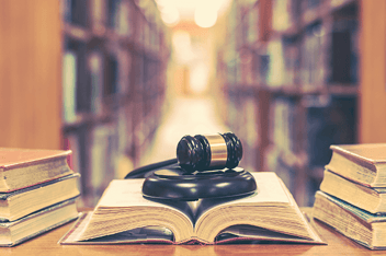 Gavel on law books in library