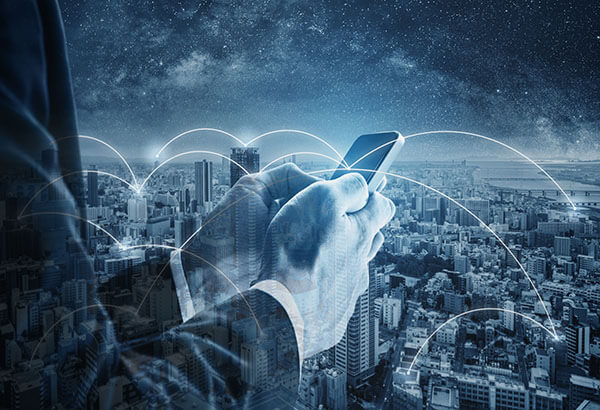 Texting on phone with city background
